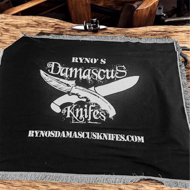 Cozy gifts Black cloth featuring "Ryno's Damascus Knives" logo and website address.